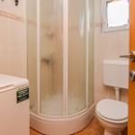 Badezimmer mit Dusche, Toilette und Waschmaschine