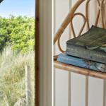 Durch runde Fensterblick auf Grünflächen. Bücher auf Bambusstuhl.