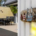 Terrasse mit Tisch und Stühlen vor gelbem Mauerwerk. Holzdekoration mit Boot und Leuchtturm an Wand.