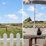 Terrasse mit Tisch, Stuhl und Sonnenschirm. Blick auf Grasland und Himmel.
