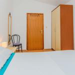 Bedroom with bed, wardrobe, and chair