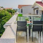 Terrace with table, chairs, and sea view.