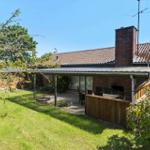 House with terrace, grill and swing in the garden.