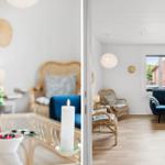 Living room with blue sofa, rattan furniture, and glass table. View of street through window.
