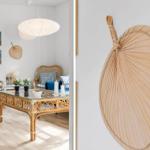 Living room with rattan furniture and glass table. Wall decor with fan.