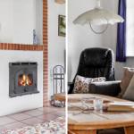 Kamin mit brennendem Holzofen und gemütlicher Sitzgruppe mit Couch und Tisch.