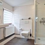 Bathroom with shower, toilet, and sink.