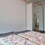 Bedroom with double bed and mirrored wardrobe.