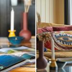 Ein Wohnbereich mit Sofa, Kissen und Tisch mit Kerzen und Buch.