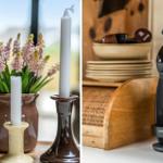 Zwei Kerzen in Vasen neben Hyazinthen. Kaffeemaschine mit Tassen und Tellern.