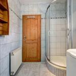Bathroom with shower, bathtub, and wooden door