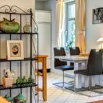 Dining room with table, chairs, and decorative shelves on the wall.