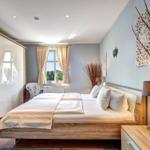 Bedroom with double bed, window, and wardrobe.