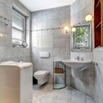 Bathroom with washing machine, toilet, and sink.