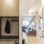 Eingangsbereich mit Kleiderschrank und Blick in Wohnbereich mit Sofa und Wandbildern.