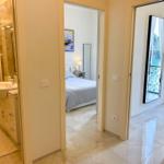 Bathroom, bedroom and balcony with water view.