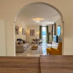 Living room with water view and balcony. Yellow armchair and sofa.