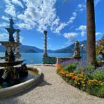 Garden with fountain, flower beds, and view of the lake