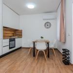 Küche mit Essbereich, Holzboden und Wanduhr