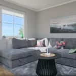 Ein Wohnzimmer mit grauem Sofa, runden Tischen und Wandbild.