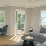 Wohn- und Essbereich mit Blick aufs Meer und Balkon.