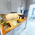 Küche mit Spüle, Arbeitsfläche und Mikrowelle.