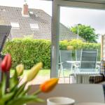 Durchgehendes Fenster mit Blick auf Terrasse und Garten.