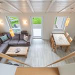 Wohn- und Essbereich mit Sofa, Tisch und Küchenzeile.