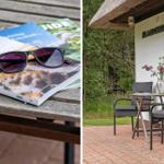 Tisch mit Reiseführern und Sonnenbrille. Außenbereich mit Tisch, Stühlen und Blumen.