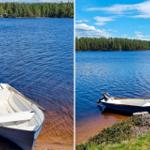 Ein weißes Boot liegt am Ufer eines blauen Sees. Im Hintergrund sind Bäume zu sehen.