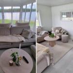 Wohnzimmer mit Sofa, Tisch und Blick auf See