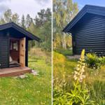 Schwarze Holzhütte mit offener Tür und Garten. Blick auf das Gebäude mit Blumen.