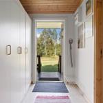 Entrance with wardrobe, pictures, and view to the terrace.