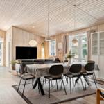 Großes Esszimmer mit Tisch, Stühlen und TV in Holzhaus