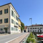 Street with houses and boats by the water