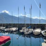 Harbor with boats and mountains in the background.