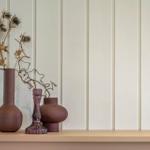 Drei Vasen mit getrockneten Pflanzen auf einer Holzoberfläche.