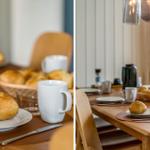 Holztisch mit Tassen, Brot und Besteck für Frühstück.