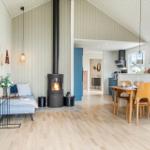 Wohn- und Essbereich mit Kamin, Holzboden und Essgruppe.