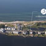 Aerial view of Strandzeitheiligenhafen with beach, buildings, and water.