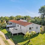 House with terrace and garden in green surroundings.