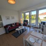 Wohn- und Essbereich mit Balkon und Blick auf die Umgebung.