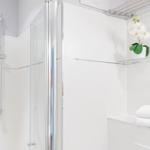 Dusche mit Glaswand, Handbrause und Handtuchhalter