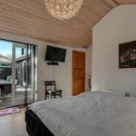 Bedroom with bed, TV, and access to the garden.