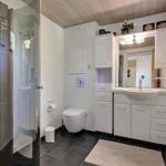 Bathroom with shower, toilet, and sink with mirror.