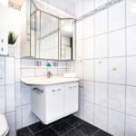 Badezimmer mit Waschbecken, Spiegelschrank und Toilette.