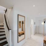 Hausflur mit Treppe, Spiegel und Kleiderständer