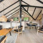 Living area with dining and kitchen under wooden roof