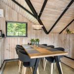 Dining area with wooden walls and table for six people.