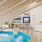 Indoor pool with hot tub and terrace